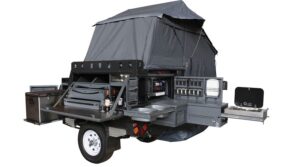 Conqueror Compact Platinum Edition trailer fully set up with rooftop tent, fridge, storage space, and kitchenette.